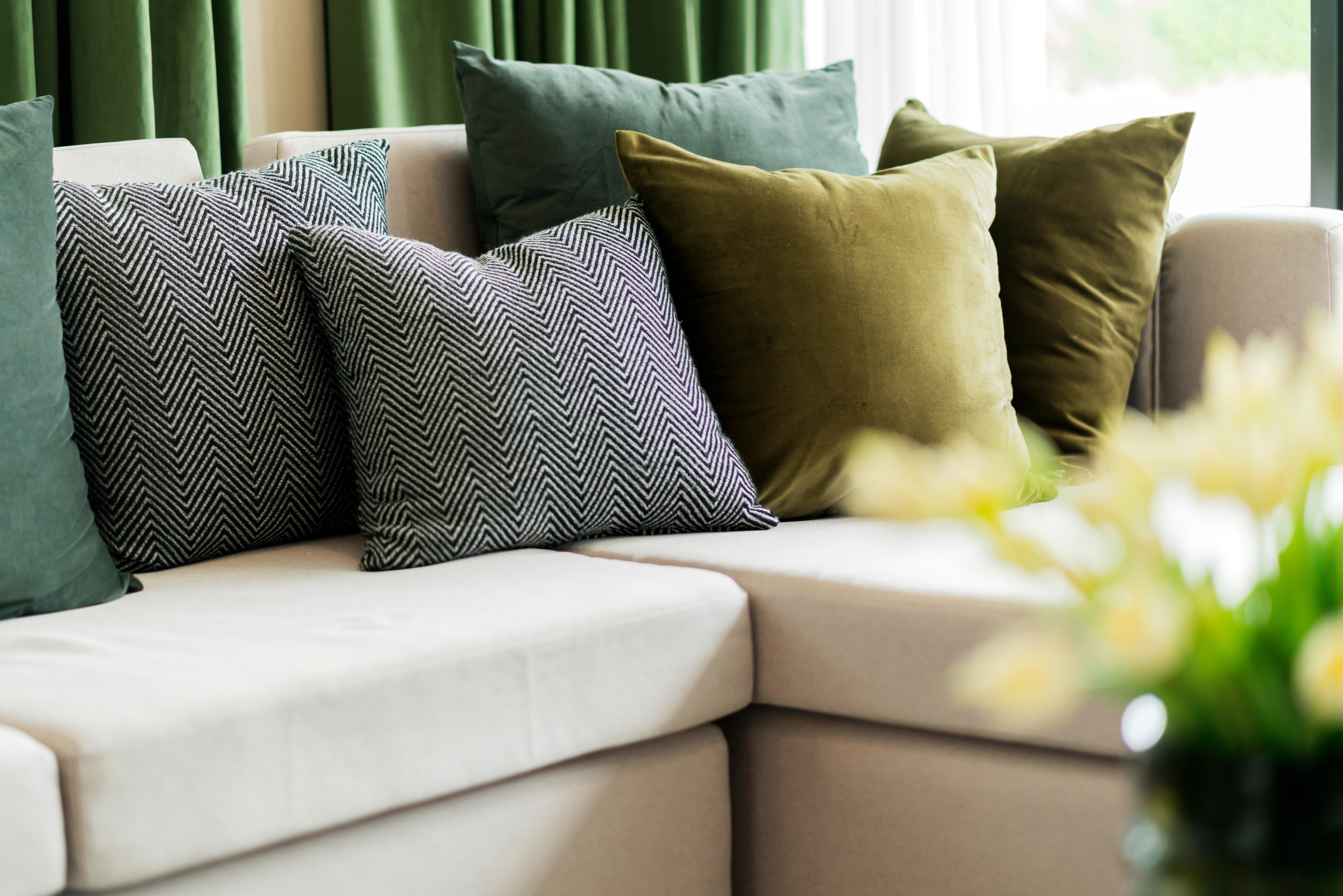 Close-up of beige earth tone pillow cushion set arrange on sofa couch in living room